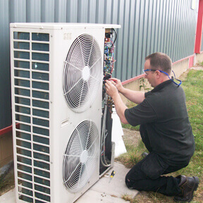 Air conditioning technician working on a unit at a customers site in Hull.